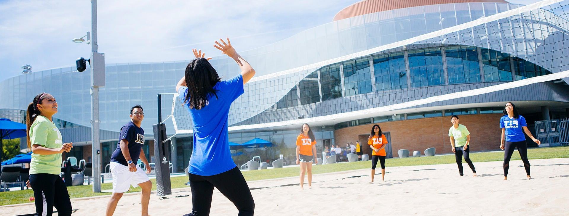 Students playing volleyball at the Recreation center